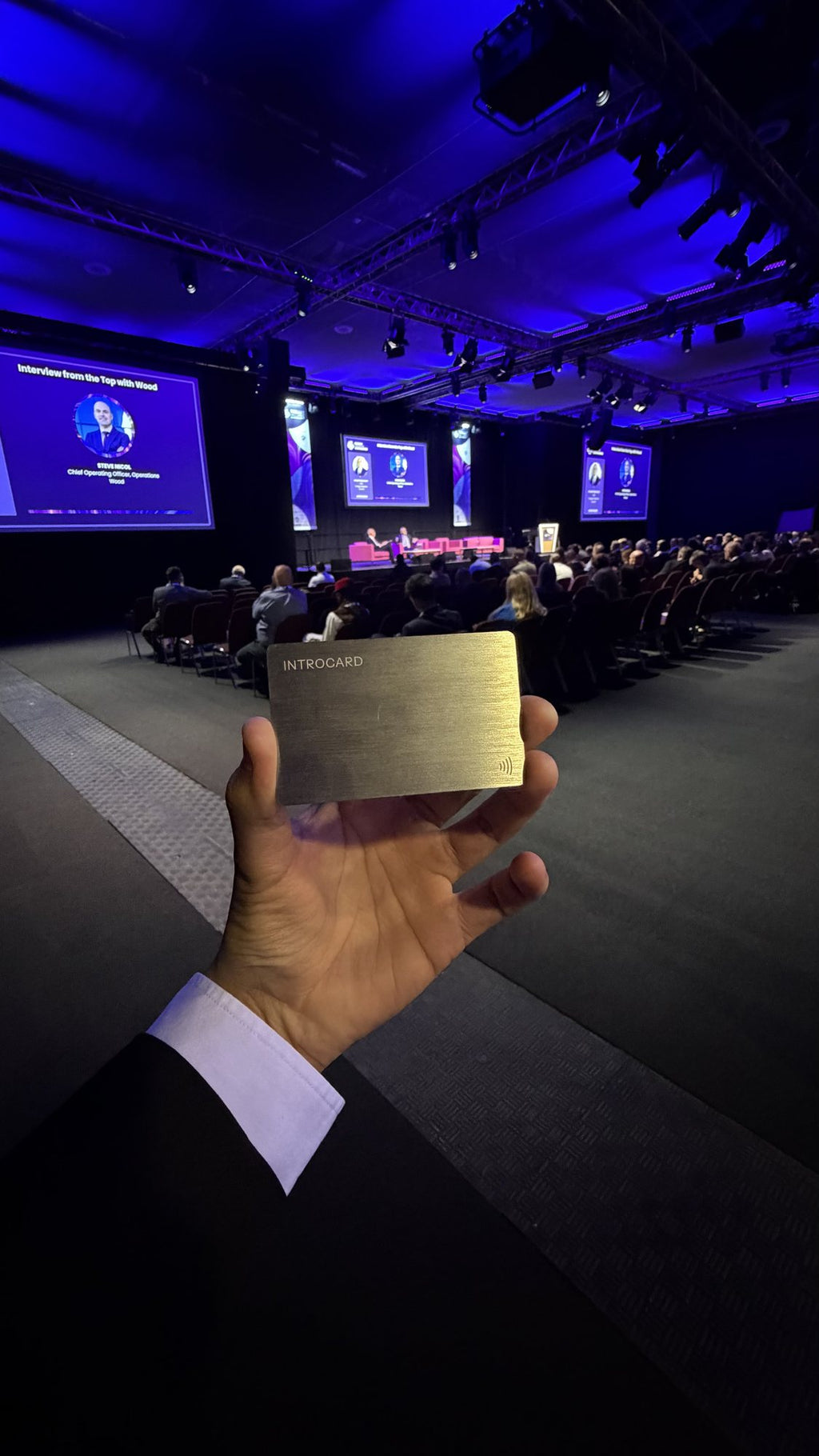 Introcard held up in a conference hall during a keynote