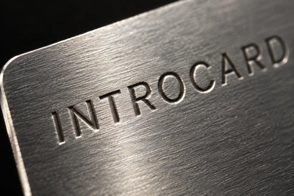Close-up of the laser-engraved INTROCARD wordmark on brushed metal
