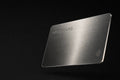 Burnished silver Introcard with laser-engraved wordmark and contactless symbol, floating against black